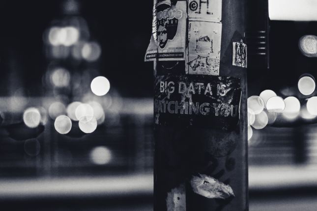 Photo of a street pole with a sticker reading "Big data is watching you"