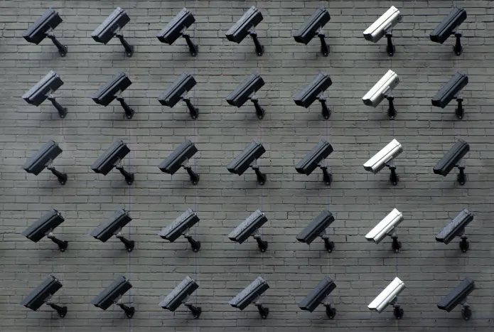 Photo of many security cameras mounted on a wall