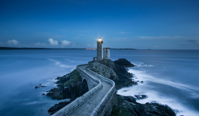 Lighthouse on a peninsula at night